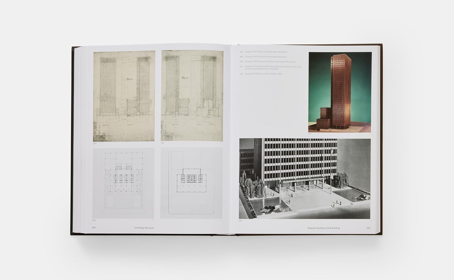 Open book displaying architectural designs on a white background