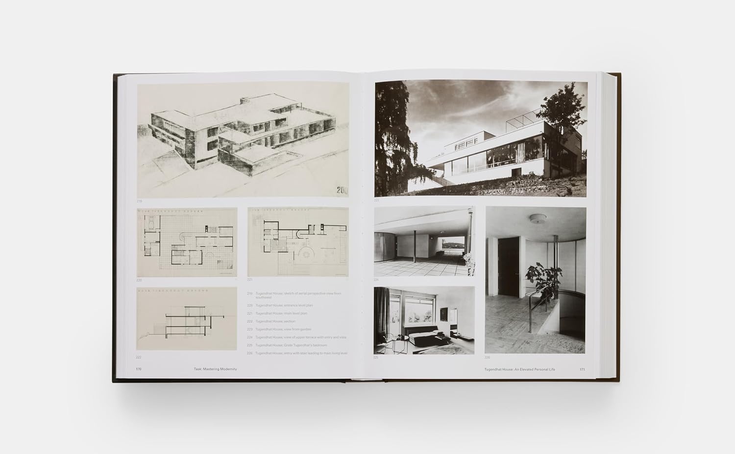 Open book displaying black and white architectural images and plans on a white background